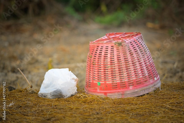 Obraz Red basket and gardener's fertilizer bag with natural background.