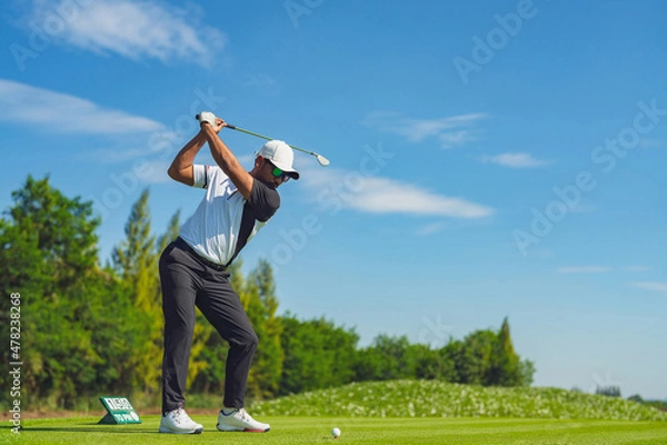 Obraz Asian man golfing on the course in summer