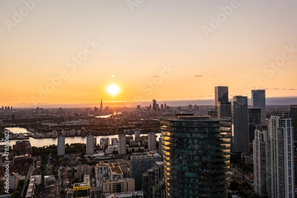 Obraz Panoramic aerial skyline view of east London at sunrise with skyscrapers of Canary Wharf and beautiful colorful sky at background