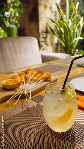 Obraz cocktail with lemon on the table in the cafe in the bar refreshing drink