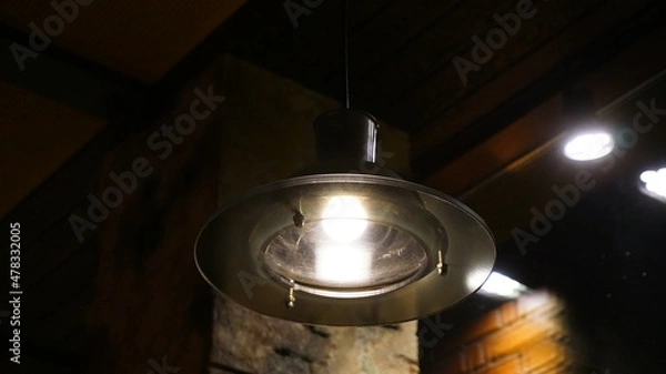 Fototapeta chandelier lamp in a cafe in a bar on the background of a brick wall