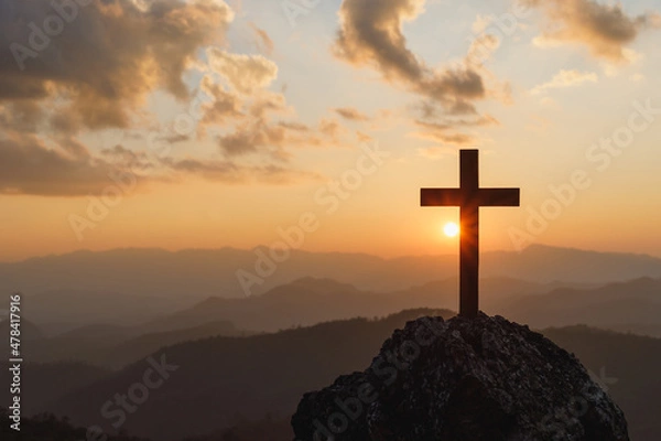 Obraz Silhouettes of crucifix symbol on top mountain with bright sunbeam on the colorful sky background