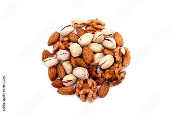 Fototapeta Various mix of nuts - almonds, pistachio, walnuts into the shape of a circle lisolated on a white background. Top view.