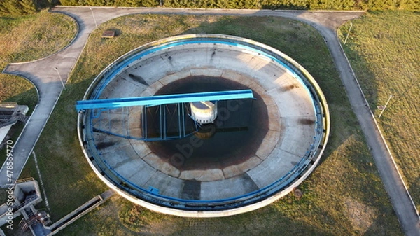 Fototapeta Aerial view of a wastewater treatment plant. During purification, chemicals and microorganisms are removed from the water and the water is returned to river and sea watercourses.
