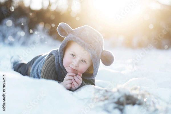 Obraz A two-year-old boy in a grey plush hood with ears.