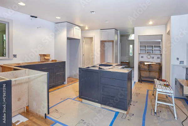 Fototapeta Custom cabinets for kitchen island, desk and counters are set in place