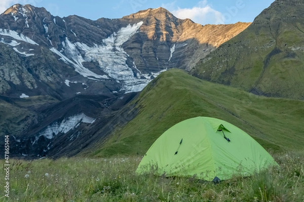 Obraz A green tent high in the mountains. Tourism and travel.