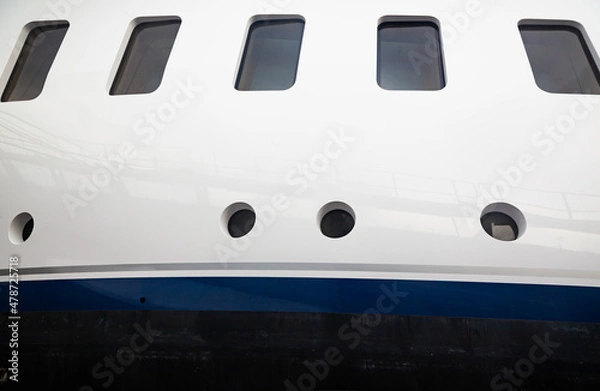 Obraz Portholes on the hull of a luxury yacht, above the waterline, side view.