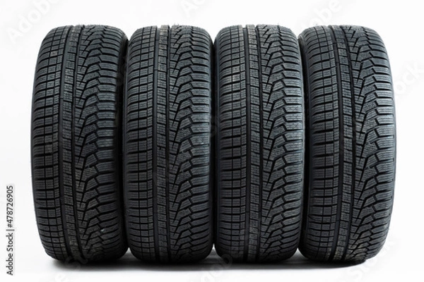 Obraz Four wheels with winter tires from front view isolated on white background. Complete set of new rubber car parts cut out on blank. Concept of safe travels.