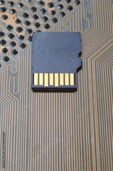 Fototapeta the black micro sd card lies on the microcircuit. close-up.