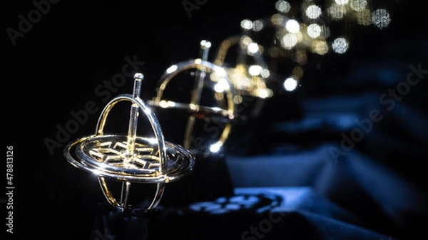 Fototapeta Golden Gyroscope Reflecting Endlessly in the Darkness