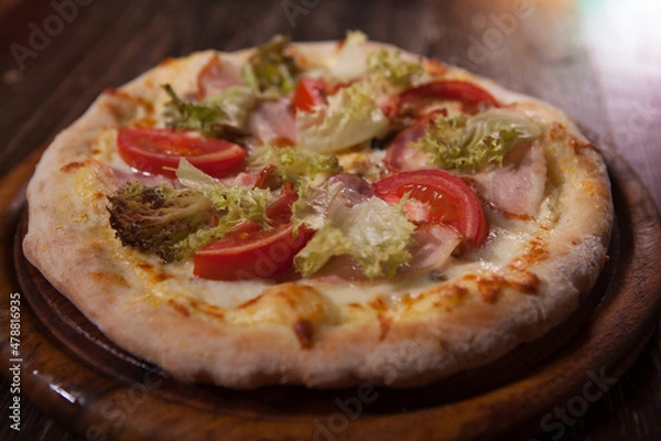 Fototapeta Close up of delicious pizza with salad and sliced ham