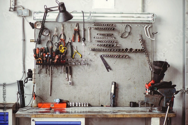 Fototapeta Locksmith's table with keys and tools for the repair of mechanical equipment. Car workshop