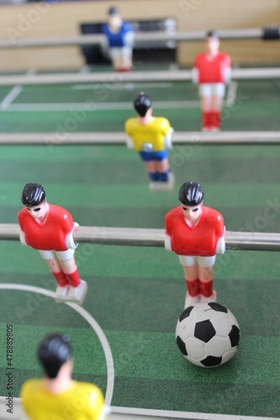 Fototapeta Close up of some players and a soccer ball from a table foosball game