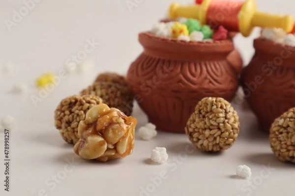Fototapeta Indian festival makar sankranti concept : Tilgul in small bowl. Tilgul is a colourful sesame candy coated with sesame seeds; in Maharashtra people exchange tilgul on Sankranti