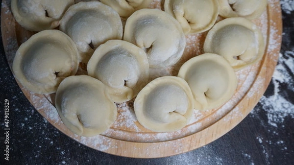 Obraz dumplings, a traditional dish of Russian cuisine, made of dough stuffed with minced meat, minced meat, cooking process, modeling, recipe