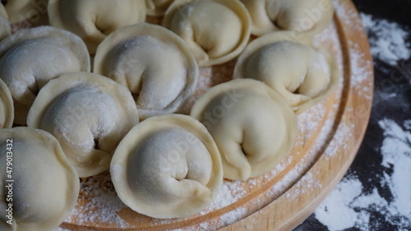Fototapeta dumplings, a traditional dish of Russian cuisine, made of dough stuffed with minced meat, minced meat, cooking process, modeling, recipe