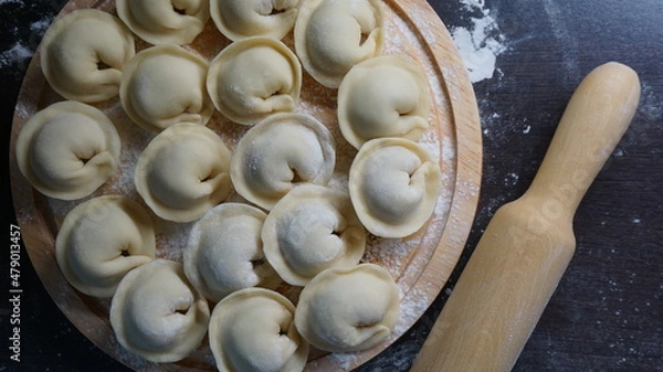 Fototapeta dumplings, a traditional dish of Russian cuisine, made of dough stuffed with minced meat, minced meat, cooking process, modeling, recipe