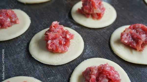 Fototapeta the process of cooking, modeling, recipe, dumplings, Traditional dish of Russian cuisine, round dough stuffed with minced meat, minced meat