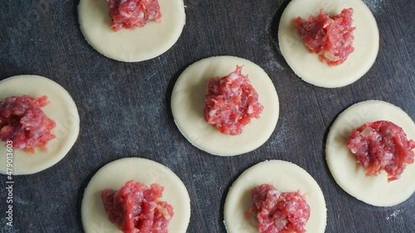 Fototapeta the process of cooking, modeling, recipe, dumplings, Traditional dish of Russian cuisine, round dough stuffed with minced meat, minced meat