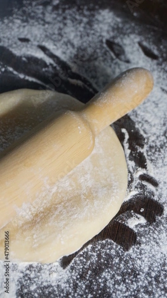 Fototapeta cooking process, modeling, recipe, dough, roll out with a wooden rolling pin, flour