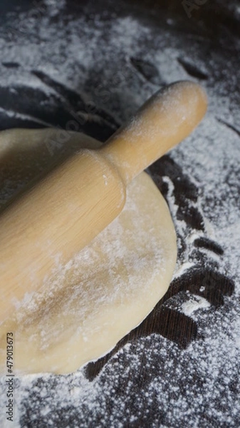 Fototapeta cooking process, modeling, recipe, dough, roll out with a wooden rolling pin, flour