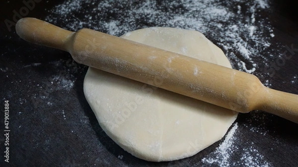 Obraz cooking process, modeling, recipe, dough, roll out with a wooden rolling pin, flour
