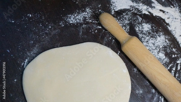 Obraz cooking process, modeling, recipe, dough, roll out with a wooden rolling pin, flour