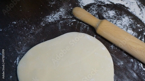 Obraz cooking process, modeling, recipe, dough, roll out with a wooden rolling pin, flour
