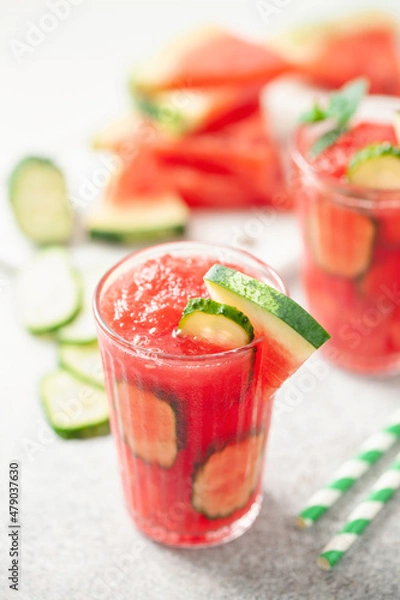 Fototapeta Refreshing cold summer drink watermelon slushie  with cucumber slices in glass