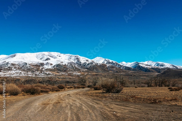 Fototapeta High cliffs in the mountains with snow on the peaks in Altai
