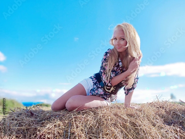 Obraz girl on the manger in summer