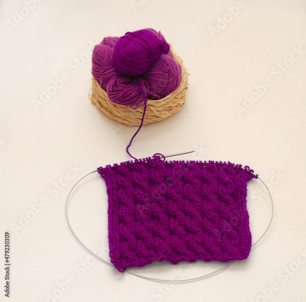 Fototapeta Balls of colored knitting threads and knitting needles on a white background. Needlework and stress relief
