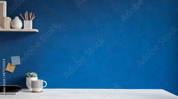 Obraz Home office desk with blue wall for mockup or copy space.