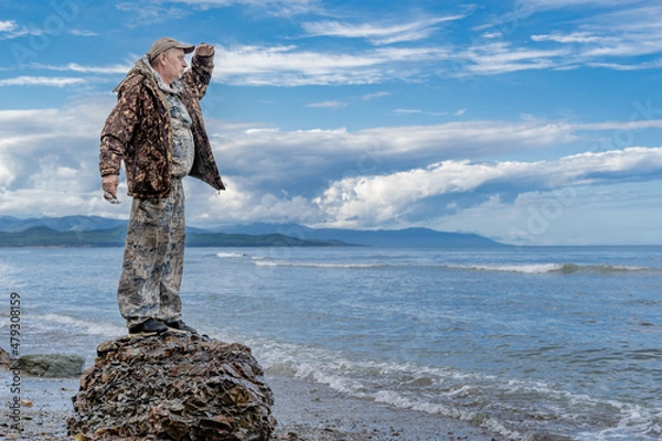 Fototapeta  Contented old man in a relaxed atmosphere enjoying a vacation by the sea. Mature retiree contemplating the sea: imagination and vision for the future.