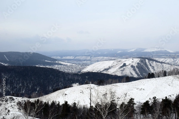 Fototapeta Sunset in the mountains. Mountain landscape in winter. Snow-covered rocks. Bad weather in the mountains. Stormy