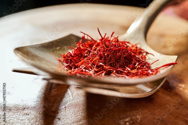 Obraz saffron threads on a copper spoon close-up
