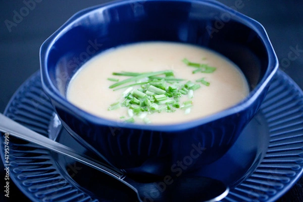 Fototapeta creamy chicken soup puree in a dark blue bowl 