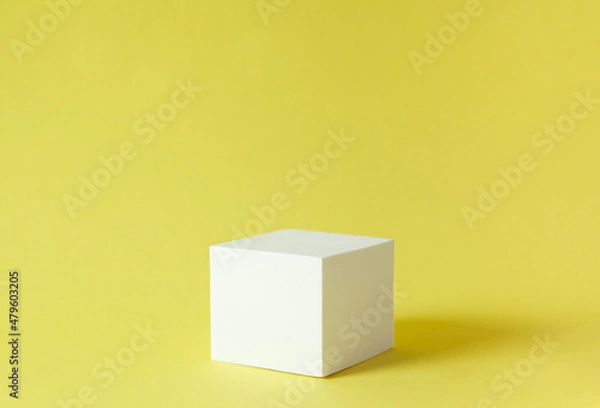 Obraz white cube on yellow background