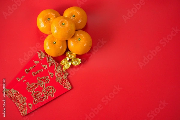 Fototapeta flatlay design for chinese new year concept with red envelope orange and gold on red background