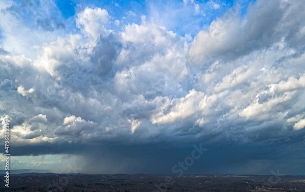 Fototapeta Scattered storm clouds with precipitation present 