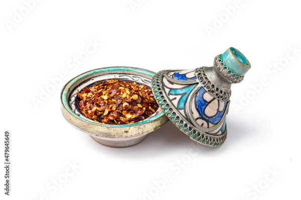 Obraz Red chilli pepper flakes in a mini Moroccan tagine