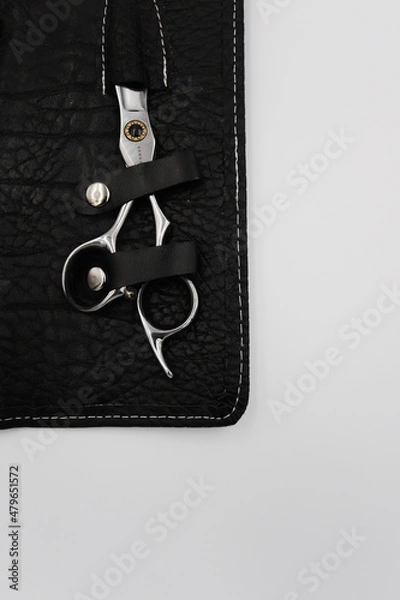 Fototapeta professional stylist scissors close-up in a black leather case