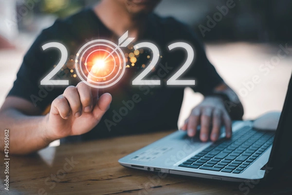 Fototapeta usiness planning and strategy in 2022, life planning in 2022, progress or success concept, businessman's hand Show letters 2022
