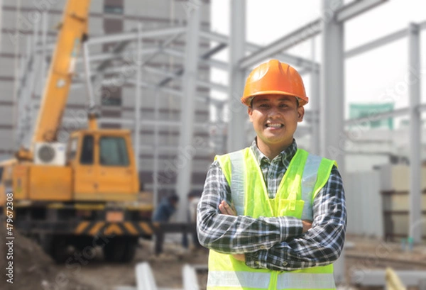 Obraz portrait of foreman construction worker on location new building site with crane in the background