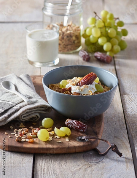 Fototapeta Fresh granola, muesli with yogurt and berries on marble background. Healthy breakfast. Copy space. Top view.