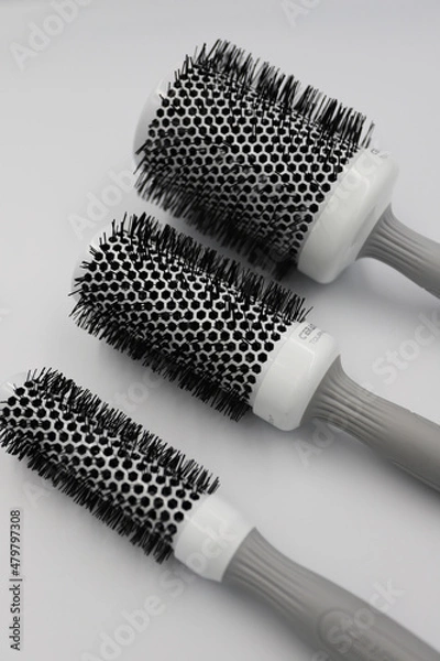 Fototapeta three round professional brushes of different sizes close-up on a light background