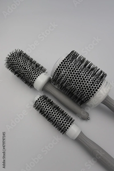 Fototapeta three round professional brushes of different sizes close-up on a light background