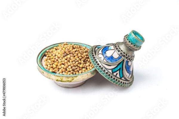 Obraz Coriander seeds in a mini Moroccan tajine