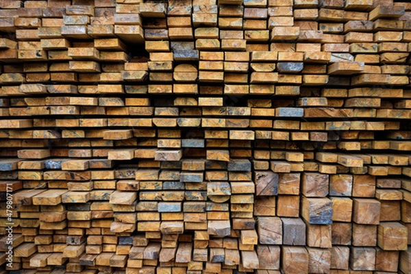 Obraz Wooden beams lie in a row. Woodworking and logging industry.